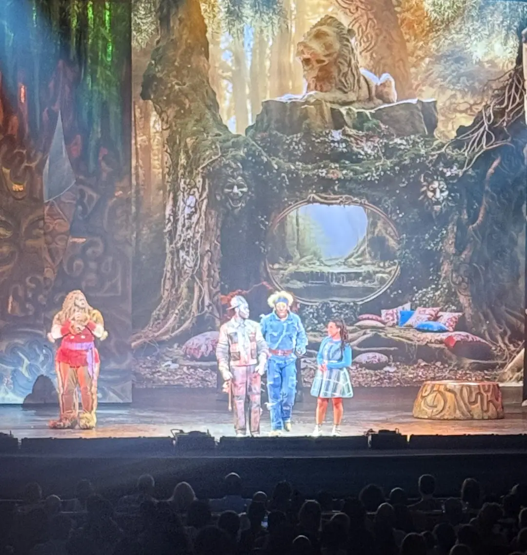 The Wiz cast in full performance glory - ensemble of performers in vibrant costumes on stage at the Academy of Music, showcasing the energy and artistry of this celebrated musical production